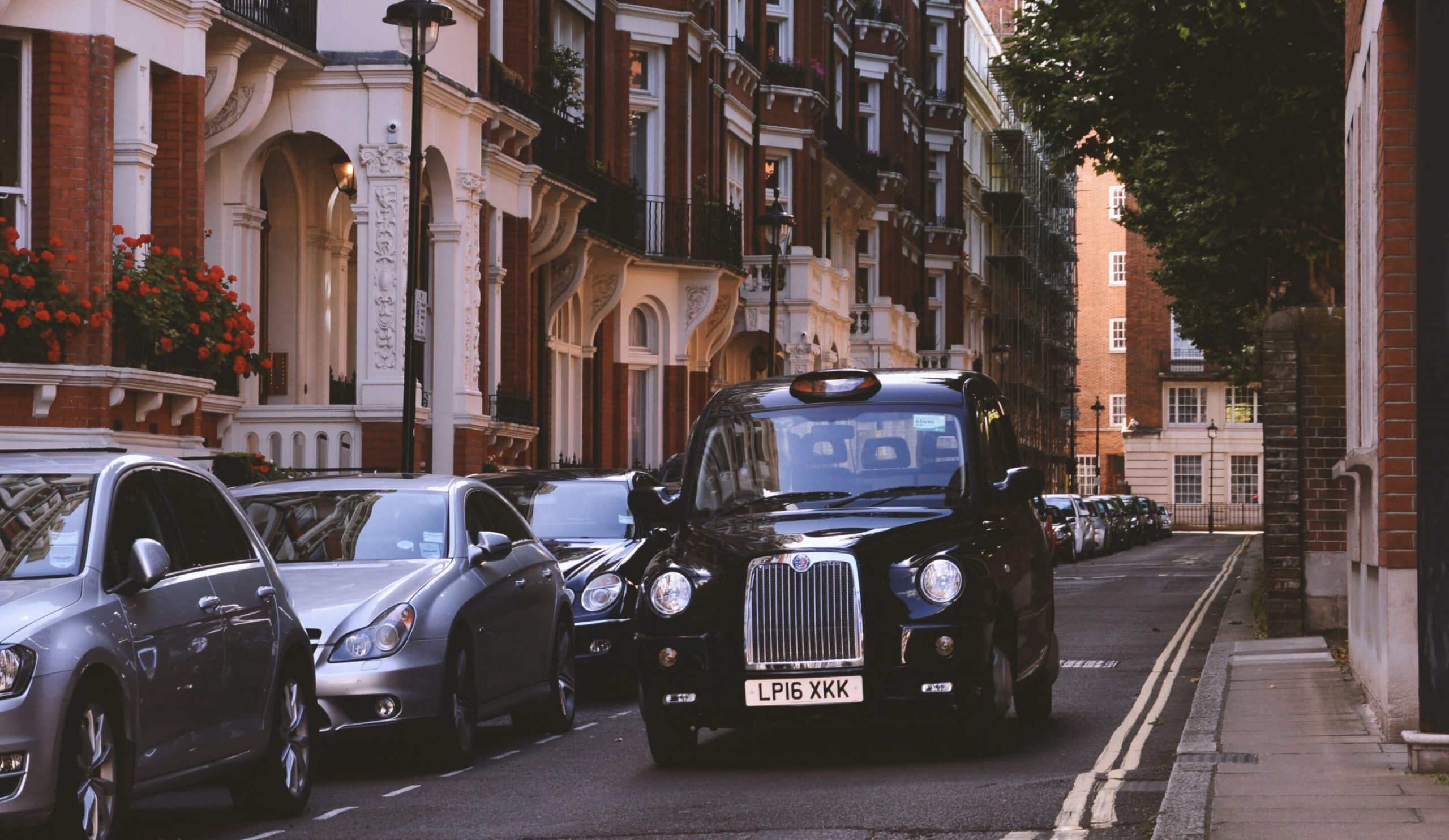 Image of a black London taxi on a residential street