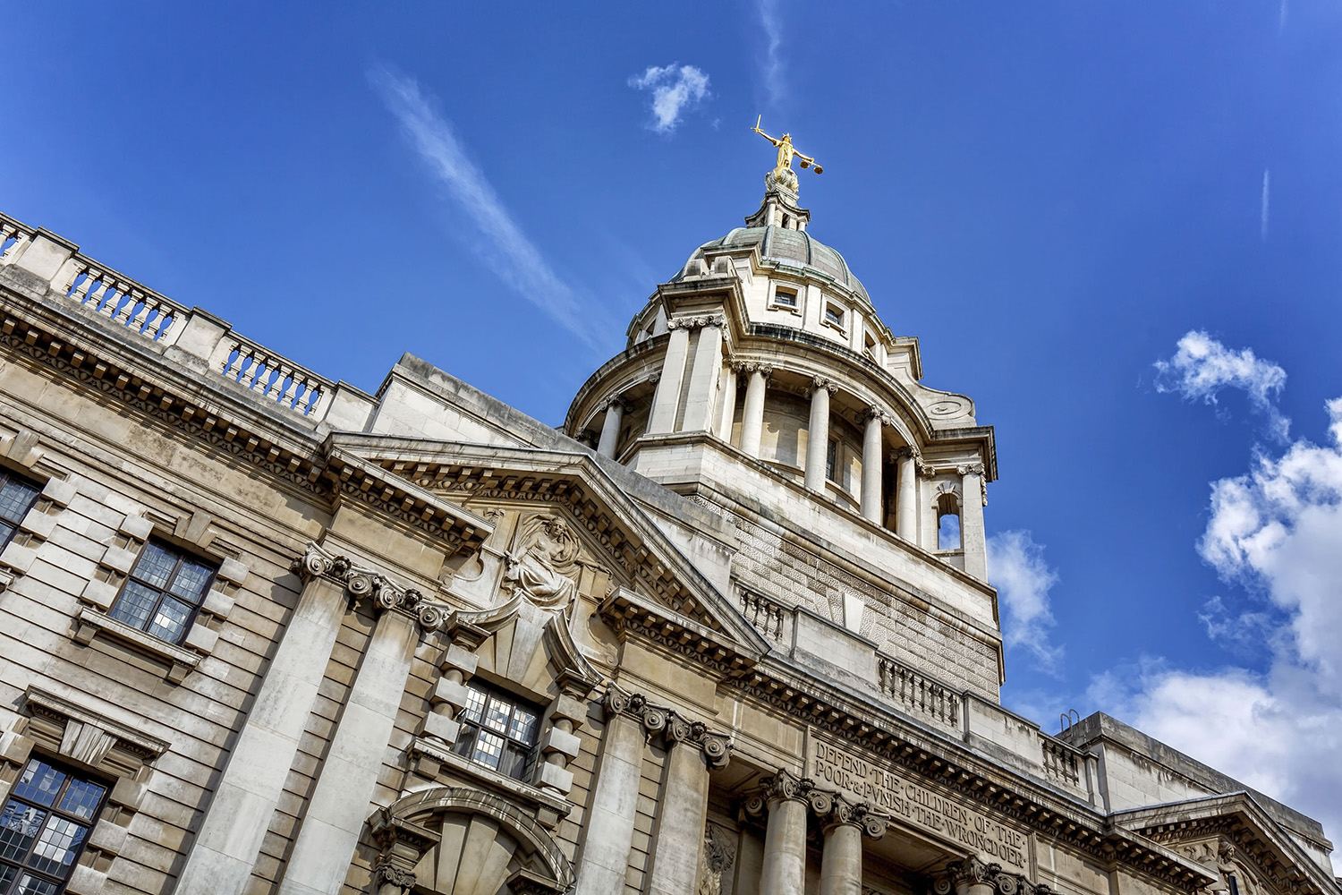 Image of a gold statue on top of an ornate building in London