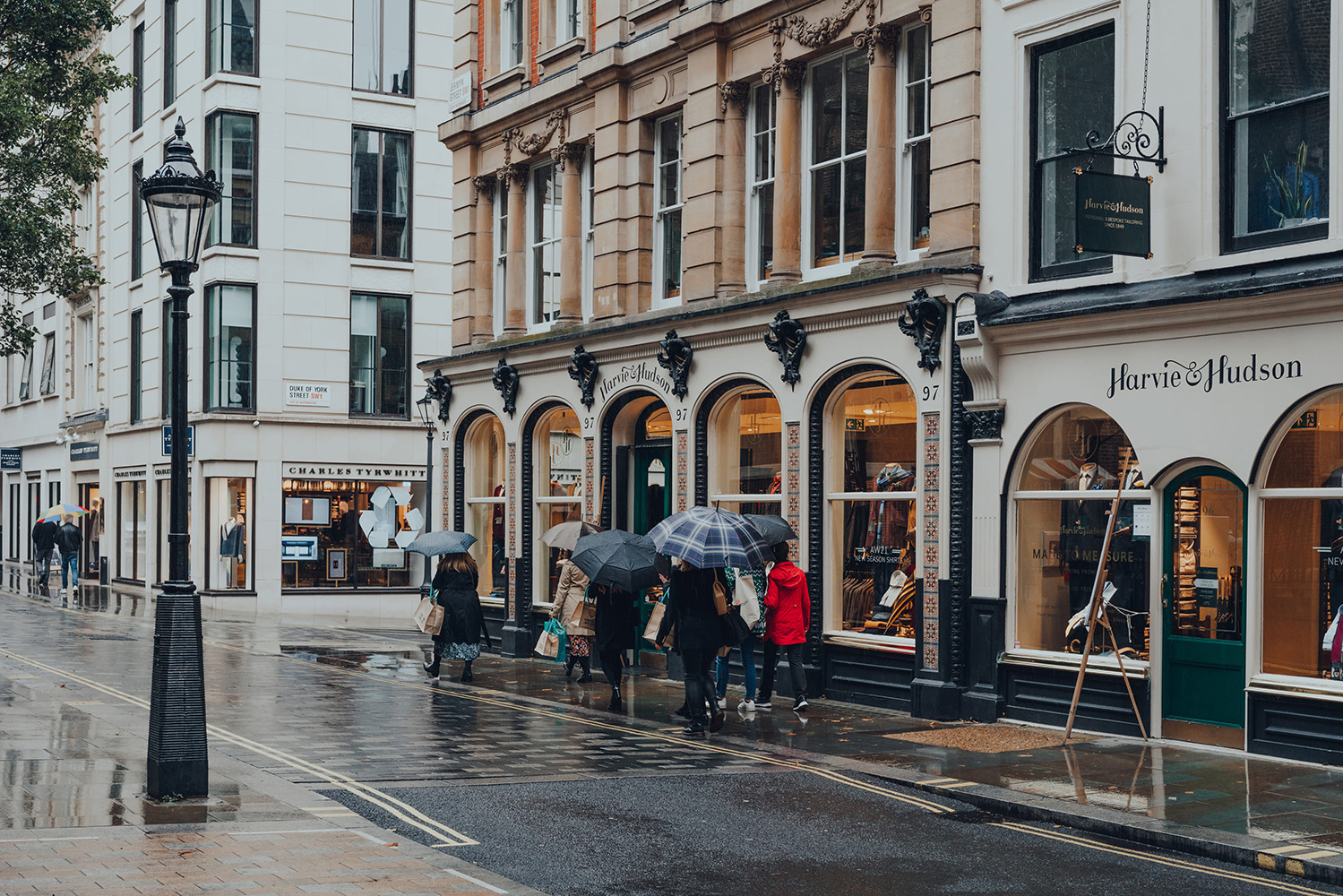 Image of shoppers in the rain near Duke of York Square, London