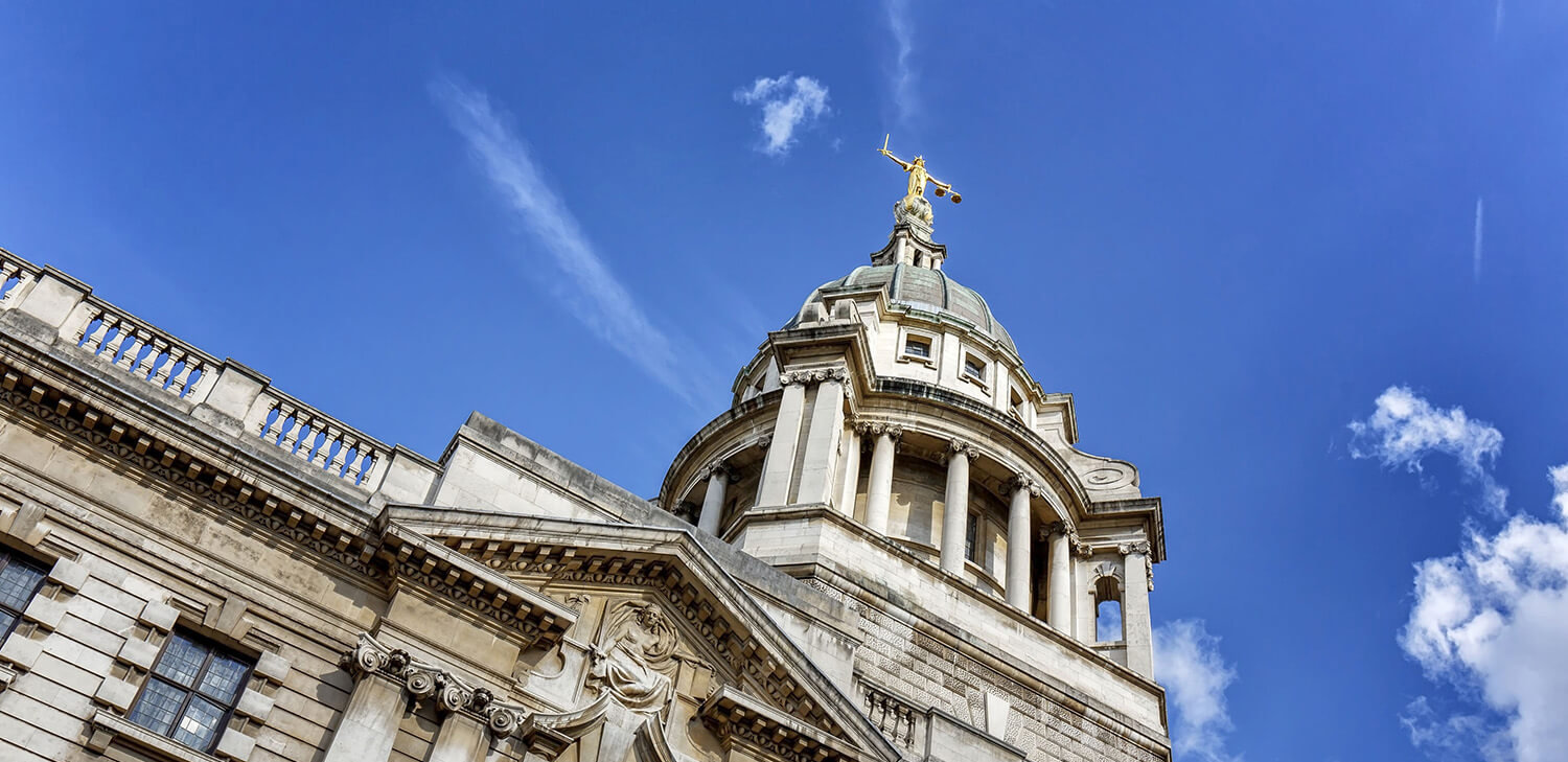 Image of a London domed rooftop with columns and a gold statue on top